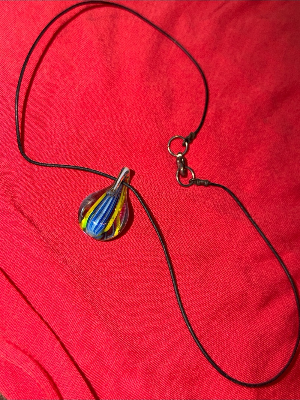 Glass pendant on black cord